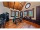 Office with a unique design boasts vaulted wood ceilings, hardwood floors, and multiple windows at 34650 Sleeping Fox Trl, Evergreen, CO 80439