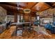 Home office with wood ceiling, stone fireplace, custom built-ins, and luxury finishes at 34650 Sleeping Fox Trl, Evergreen, CO 80439