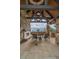 Covered patio with stone fireplace and seating, offering breathtaking mountain views at 34650 Sleeping Fox Trl, Evergreen, CO 80439