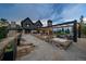 Inviting outdoor patio with stone fireplace, water features, and cozy seating, perfect for entertaining with mountain views at 34650 Sleeping Fox Trl, Evergreen, CO 80439