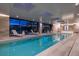 Elegant indoor pool featuring abundant natural light and inviting lounge chairs for ultimate relaxation at 34650 Sleeping Fox Trl, Evergreen, CO 80439