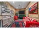 Unique recreation room with automotive-themed decor and comfortable seating, perfect for relaxing and entertaining at 34650 Sleeping Fox Trl, Evergreen, CO 80439
