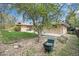 Spacious backyard with green lawn, mature tree, stone landscaping and brick home at 4740 Lee Cir, Boulder, CO 80303