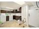 Laundry room features dark brown cabinetry, a washer, dryer, freezer and storage space at 4740 Lee Cir, Boulder, CO 80303