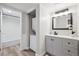 Modern bathroom featuring granite counters, updated vanity, and shower over tub at 9700 E Iliff Ave # A3, Denver, CO 80231