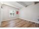 Bedroom with beamed ceilings, wood-look floors, and large window at 9700 E Iliff Ave # A3, Denver, CO 80231