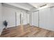 Bright bedroom featuring hardwood floors, spacious closet, and ensuite bathroom access at 9700 E Iliff Ave # A3, Denver, CO 80231