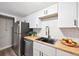 Renovated kitchen with stainless steel appliances, butcher block counters and white cabinets at 9700 E Iliff Ave # A3, Denver, CO 80231
