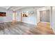 Open-concept living room with hardwood flooring, white trim, and access to kitchen at 9700 E Iliff Ave # A3, Denver, CO 80231