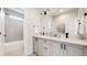 Modern bathroom showcasing a double vanity with quartz countertops and elegant fixtures at 5567 Moosehead Cir, Longmont, CO 80503