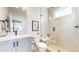 Elegant bathroom with modern vanity, toilet, and spacious glass-enclosed shower, offering a luxurious experience at 5567 Moosehead Cir, Longmont, CO 80503