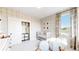 Bedroom with plaid accent wall, closet, and abundant natural light creating a serene space at 5567 Moosehead Cir, Longmont, CO 80503