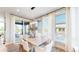 Bright dining room with modern light fixture and sliding doors to the outdoor patio at 5567 Moosehead Cir, Longmont, CO 80503