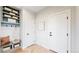 Mudroom with built-in bench, storage shelves, hooks, and herringbone-patterned floors at 5567 Moosehead Cir, Longmont, CO 80503