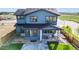 Striking two-story home showcasing blue siding, a well-manicured lawn, and inviting front porch at 5567 Moosehead Cir, Longmont, CO 80503