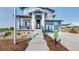 Inviting front entrance with stone accents, professional landscaping, and visible model home sign at 5567 Moosehead Cir, Longmont, CO 80503