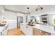 Modern kitchen with stainless steel appliances flows into the living area with a fireplace at 5567 Moosehead Cir, Longmont, CO 80503