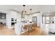 Modern kitchen featuring a center island with bar stool seating and stainless steel appliances at 5567 Moosehead Cir, Longmont, CO 80503