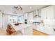 Modern kitchen with stainless steel appliances and white cabinetry extending into the dining area at 5567 Moosehead Cir, Longmont, CO 80503