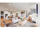 Open-concept living room flowing into the kitchen, featuring stylish decor and abundant natural light at 5567 Moosehead Cir, Longmont, CO 80503