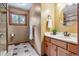 Cozy bathroom featuring wood accents, vanity, and a view to the outdoors at 6723 Perry Park Blvd, Larkspur, CO 80118