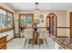 Bright dining room featuring pendant lighting, a glass top table, and views to the outdoors at 6723 Perry Park Blvd, Larkspur, CO 80118