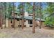 Exterior view of a two-story home with mature trees and lush landscaping at 6723 Perry Park Blvd, Larkspur, CO 80118