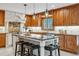 Spacious kitchen with granite countertops, stainless steel appliances, and a large island with seating at 6723 Perry Park Blvd, Larkspur, CO 80118