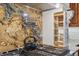 Kitchen with stone backsplash, pot filler, stainless appliances, and built-in wooden pull-out shelves at 6723 Perry Park Blvd, Larkspur, CO 80118