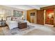 Comfortable main bedroom with a decorative rug, wood accents, and barn door to ensuite at 6723 Perry Park Blvd, Larkspur, CO 80118