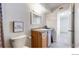 Well-lit bathroom with a wood vanity, granite counters and modern fixtures at 12101 Melody Dr # 202, Westminster, CO 80234