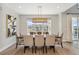 Bright dining room featuring modern light fixture, neutral decor, and expansive windows with neighborhood views at 52 Simmental Loop, Castle Rock, CO 80104