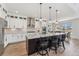 Stylish kitchen featuring white cabinets, stainless appliances, and a granite-topped center island at 52 Simmental Loop, Castle Rock, CO 80104