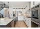 Bright kitchen featuring white cabinets, stainless steel appliances, granite countertops, and stylish pendant lighting at 52 Simmental Loop, Castle Rock, CO 80104