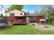 The backyard features a deck, fire pit, trampoline, playhouse, lawn, and a privacy fence at 821 Clarkson Ct, Denver, CO 80229