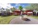 The backyard features a deck, fire pit, trampoline, playhouse, lawn, and a privacy fence at 821 Clarkson Ct, Denver, CO 80229