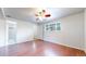 This bedroom features ample sunlight, wood floors, and an adjacent bathroom at 821 Clarkson Ct, Denver, CO 80229