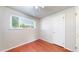 This bedroom features a window and door with wood flooring and neutral walls at 821 Clarkson Ct, Denver, CO 80229