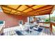 Relaxing outdoor covered patio with wood ceiling, table, and chairs, conveniently located by the house at 821 Clarkson Ct, Denver, CO 80229