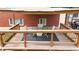 Relaxing outdoor covered patio with wood ceiling, table, and chairs overlooking backyard at 821 Clarkson Ct, Denver, CO 80229