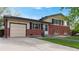 Charming brick home with solar panels, a well-maintained lawn, and attached garage at 821 Clarkson Ct, Denver, CO 80229