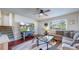 Cozy living room with hardwood floors, a ceiling fan, and a large window at 821 Clarkson Ct, Denver, CO 80229
