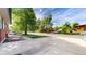 Street view of home with front lawn, driveway, mature trees, and ample street parking at 821 Clarkson Ct, Denver, CO 80229