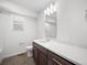 A bathroom featuring a toilet, single sink vanity and large mirror at 1164 Sugarloaf Ln, Erie, CO 80516