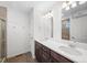 Bathroom with double sink vanity, modern fixtures, and tile flooring at 1164 Sugarloaf Ln, Erie, CO 80516