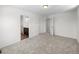 A spacious bedroom with neutral carpet leading to the bathroom and closet at 1164 Sugarloaf Ln, Erie, CO 80516