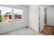 Bright bedroom with two windows and a door leading to the bathroom at 1164 Sugarloaf Ln, Erie, CO 80516