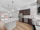 Kitchen featuring stainless steel appliances, center island, dark wood cabinets and an open concept floorplan at 1164 Sugarloaf Ln, Erie, CO 80516