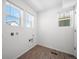 Clean laundry room features white walls and two windows for lots of natural light at 1164 Sugarloaf Ln, Erie, CO 80516