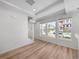 Bright living room with large windows, recessed lighting, and hardwood floors at 1164 Sugarloaf Ln, Erie, CO 80516